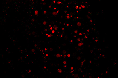 Abstract red bokeh with black backgroundの写真素材