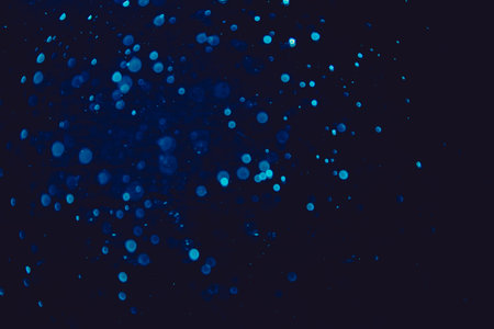Vintage blue bokeh created by neon lights with black backgroundの写真素材
