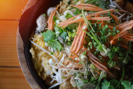Hot pot oyster omelette  in hot pan on wooden backgroundの写真素材