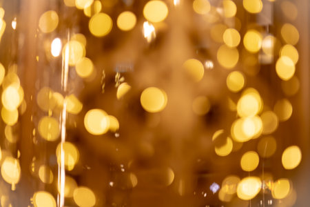Abstract gold bokeh from light with black backgroundの写真素材