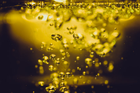 Concept Christmas gold Sparkling Lights Festive bokeh abstract from water twinkled bright bokeh defocused with black backgroundの写真素材