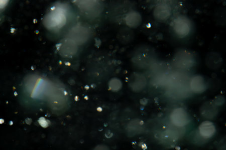 Concept Christmas silver Sparkling Lights Festive bokeh abstract defocused of lights on black...