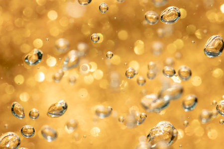 Golden abstract sparkles or glitter lights Defocused circles bokeh backgroundの写真素材