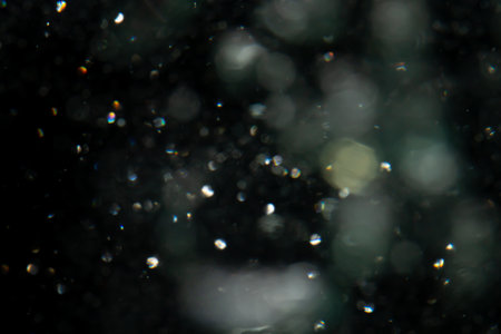 Concept Christmas silver Sparkling Lights Festive bokeh abstract defocused of lights on black backgroundの写真素材