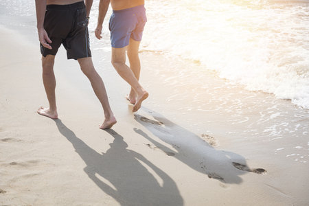 Two friends walking relax on the beach and footprints on the beachの写真素材
