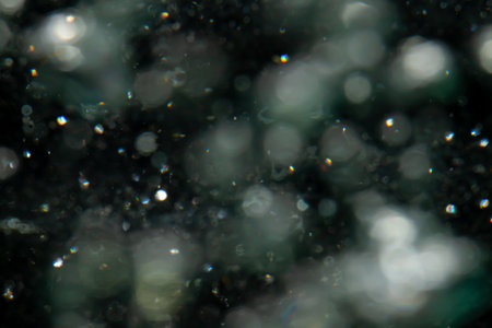 bokeh of lights from water on black backgroundの写真素材