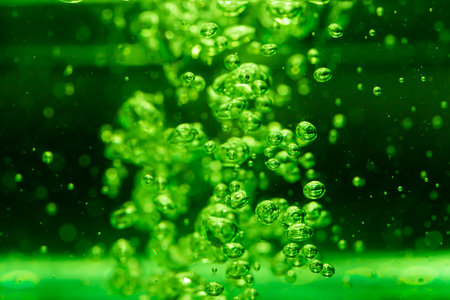 Concept Christmas green Sparkling Lights Festive bokeh abstract from water twinkled bright bokeh defocused with black backgroundの写真素材