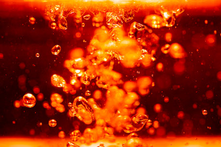 Concept Christmas red Sparkling Lights Festive bokeh abstract from water twinkled bright bokeh defocused with black backgroundの写真素材