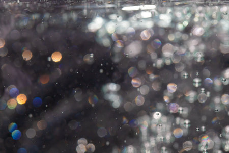 bokeh of lights from water on black backgroundの写真素材