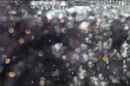 bokeh of lights from water on black backgroundの写真素材