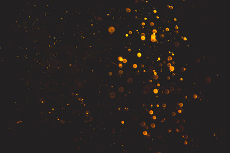 Vintage gold bokeh created by neon lights with black backgroundの写真素材