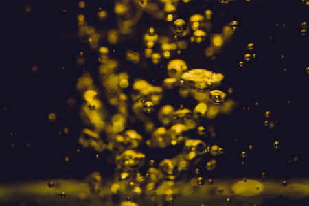Concept Christmas gold Sparkling Lights Festive bokeh abstract from water twinkled bright bokeh defocused with black backgroundの写真素材