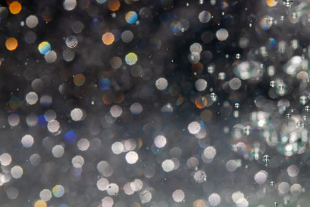 bokeh of lights from water on black backgroundの写真素材