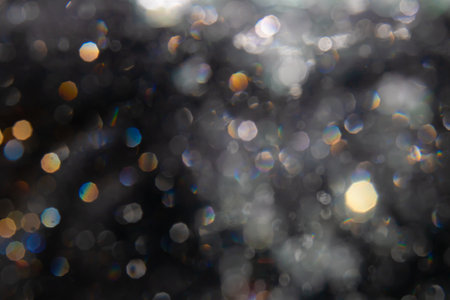 bokeh of lights from water on black backgroundの写真素材