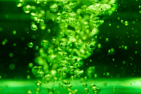 Concept Christmas green Sparkling Lights Festive bokeh abstract from water twinkled bright bokeh defocused with black backgroundの写真素材