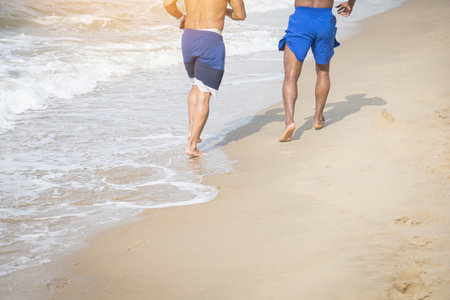 Two friends walking relax on the beach and footprints on the beachの写真素材