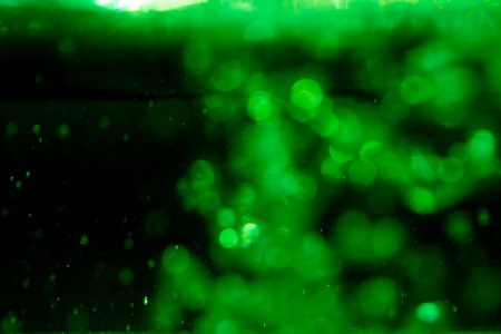 Concept Green Sparkling Lights Festive bokeh abstract Christmas twinkled bright bokeh defocused with black backgroundの写真素材