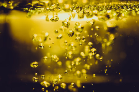 Concept Christmas gold Sparkling Lights Festive bokeh abstract from water twinkled bright bokeh defocused with black backgroundの写真素材