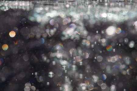 bokeh of lights from water on black backgroundの写真素材