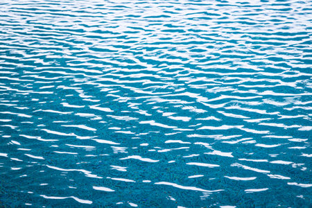 Light Blue swimming pool rippled water texture reflectionの写真素材