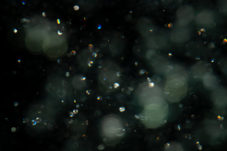Concept Christmas silver Sparkling Lights Festive bokeh abstract defocused of lights on black backgroundの写真素材
