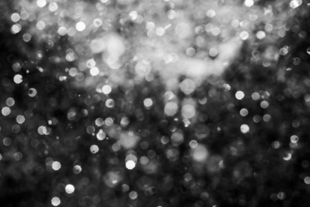 Black abstract sparkles or glitter lights Defocused circles bokeh backgroundの写真素材