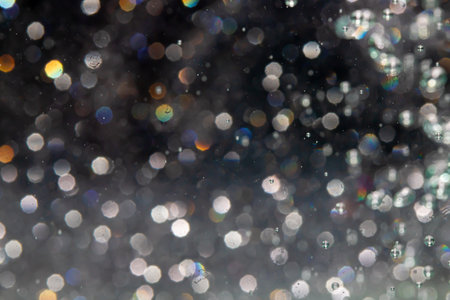 bokeh of lights from water on black backgroundの写真素材