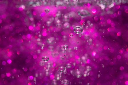 Abstract purple bokeh with black background.の写真素材