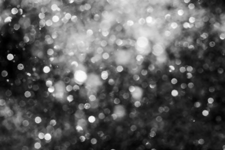 Black abstract sparkles or glitter lights Defocused circles bokeh backgroundの写真素材
