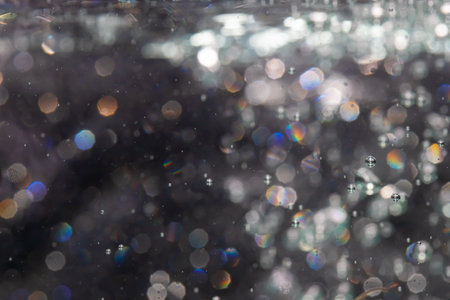 bokeh of lights from water on black backgroundの写真素材
