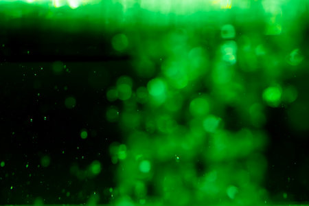 Concept Green Sparkling Lights Festive bokeh abstract Christmas twinkled bright bokeh defocused with black backgroundの写真素材