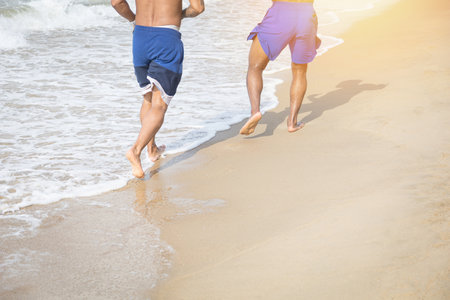 Two friends walking relax on the beach and footprints on the beachの写真素材