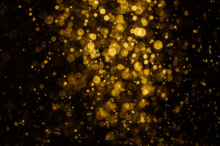 Blurred photo with golden dots visible glittering, shining brightly look and feel luxurious Suitable for use as a wallpaperの写真素材