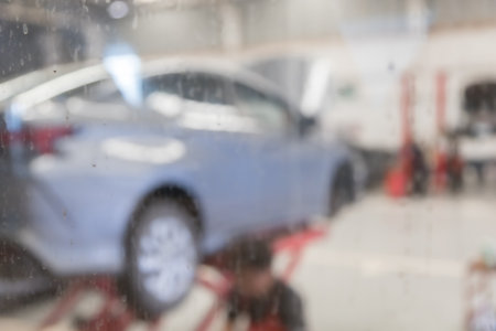 blured image of car service centre auto repair workshop use for backgroundの写真素材