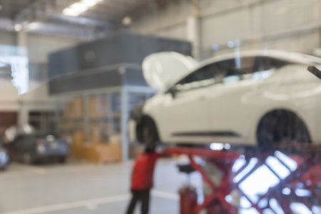 blured image of car service centre auto repair workshop use for backgroundの写真素材