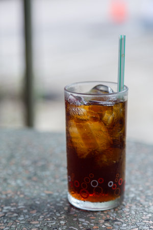 Cola with crushed ice and a straw in a clear glass is ready to drink to quench your thirst and keep you refreshed.の写真素材