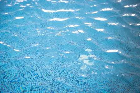 Light Blue swimming pool rippled water texture reflectionの写真素材