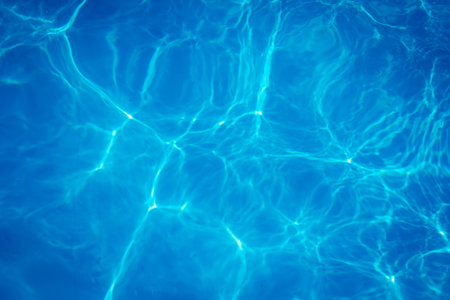 The light reflects blue in the water in the swimming pool. It looks fresh and lively, suitable for use as a wallpaper backgroundの写真素材