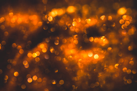 Bokeh from blurred orange flame on black backgroundの写真素材