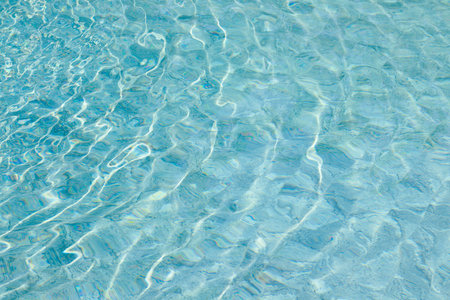 Background of rippled pattern of clean water in a swimming poolの写真素材