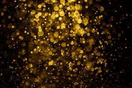 Blurred photo with golden dots visible glittering, shining brightly look and feel luxurious Suitable for use as a wallpaperの写真素材
