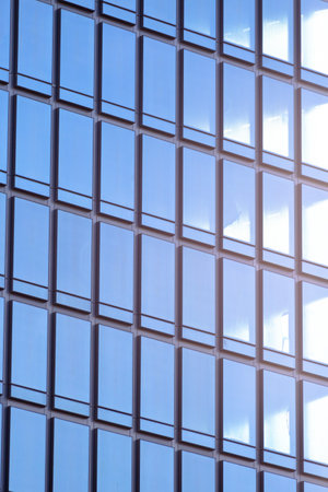 The modern building in the business district has glass windows to let in the light. Heat protection, reduce power consumptionの写真素材