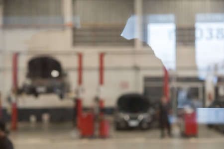 blured image of car service centre auto repair workshop use for backgroundの写真素材