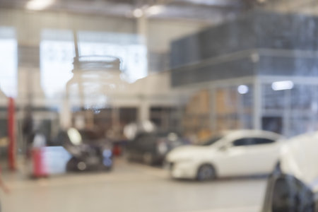 blured image of car service centre auto repair workshop use for backgroundの写真素材