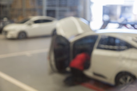 blured image of car service centre auto repair workshop use for backgroundの写真素材