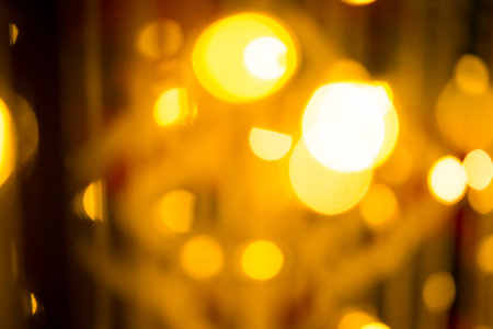 close-up blurred photo Golden decorative lights create a luxurious atmosphere at night events. Helps to take beautiful, easy and interesting photos.の写真素材