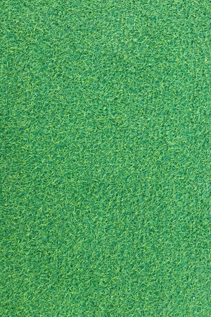 Close-up of lush green artificial grass with detailed texture and vibrant color.の写真素材