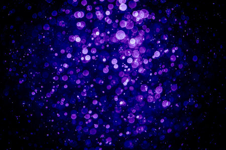 Blurred photo with purple violet and blue dots visible glittering, shining brightly look and feel luxurious Suitable for use as a wallpaperの写真素材