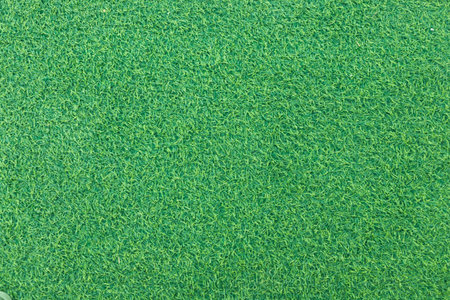 Close-up of lush green artificial grass with detailed texture and vibrant color.の写真素材