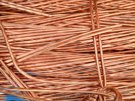 Interwoven copper wires showcasing complex twists and reflective textures.の写真素材